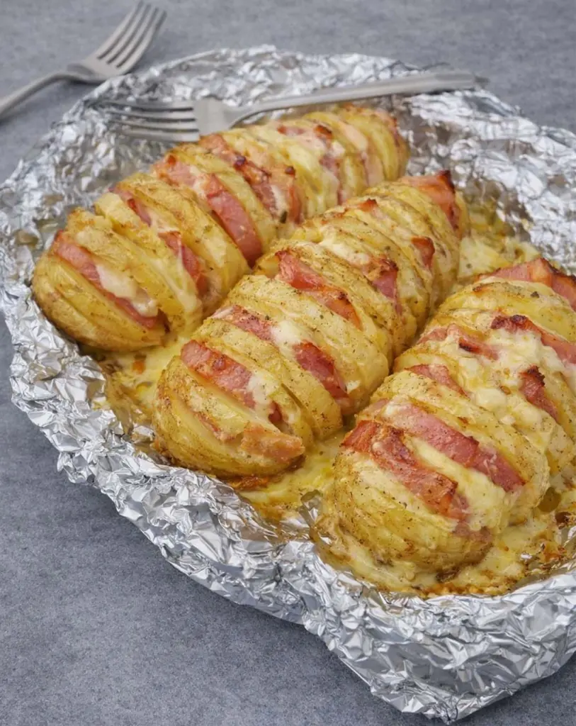 Pommes de terre Hasselback à la raclette et au bacon : recette gourmande au four